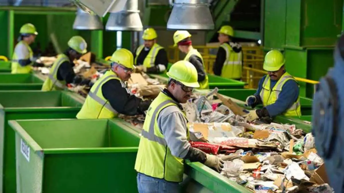 Waste Management employees on duty inside the waste facility.