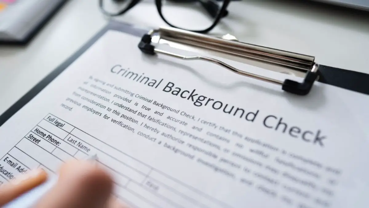 A hand writing on the Criminal Background Check document.